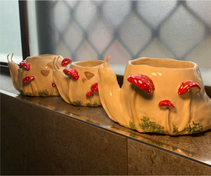 Three hand-sculpted mushroom snail planters