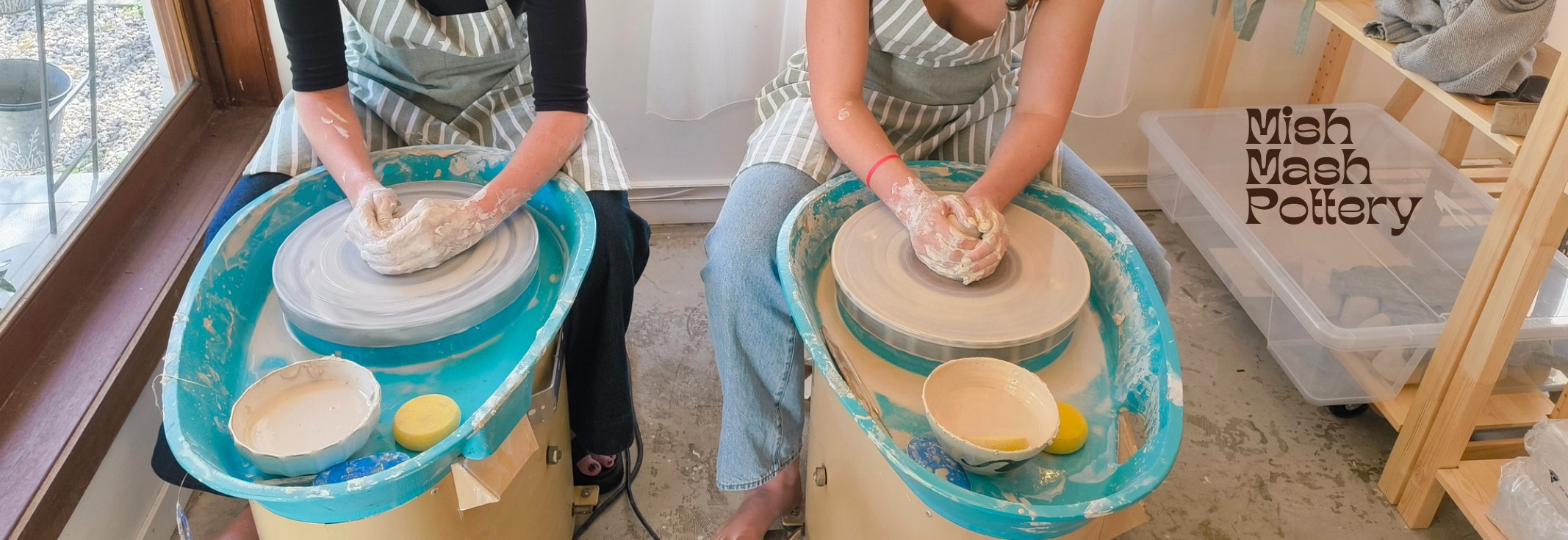 Two students shaping clay on pottery wheels at Mish Mash Pottery