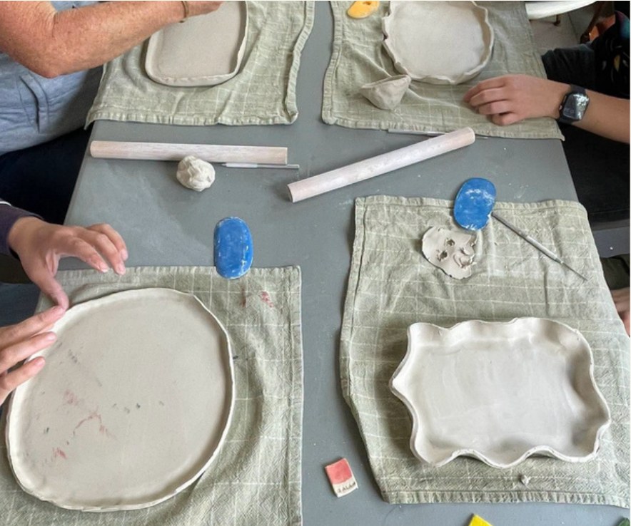 Hand-built dinner plates being shaped on the table