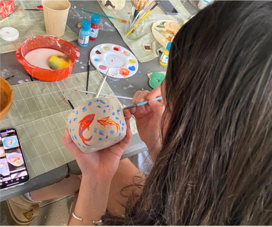 Student underglazing a hand-built piece